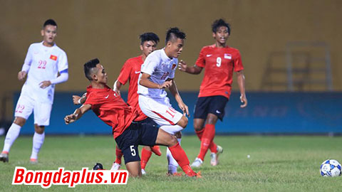 U19 Singapore (áo đỏ) vất vả chống đỡ những pha lên bóng của đội chủ nhà - Ảnh: Đức Cường