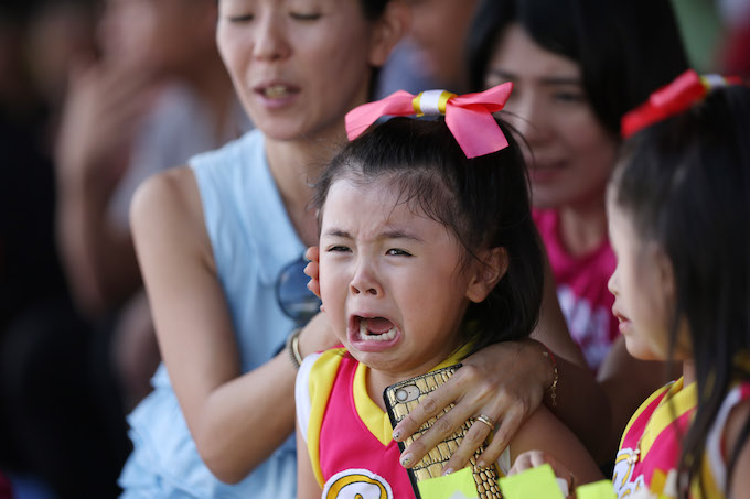 Một khán giả nhí đã khóc theo khi nhìn thấy các cầu thủ Nhật Bản rơi nước mắt vì thất bại ở trận chung kết