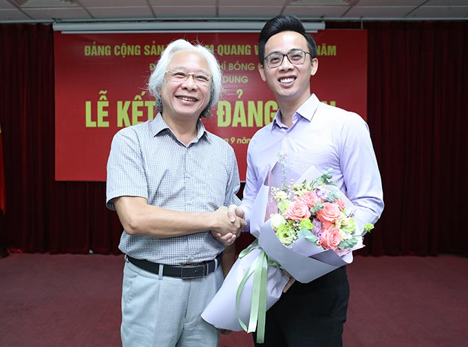 Đồng chí Nguyễn Văn Phú - Nguyên Bí thư Đảng ủy, Tổng biên tập chúc mừng đồng chí đảng viên mới