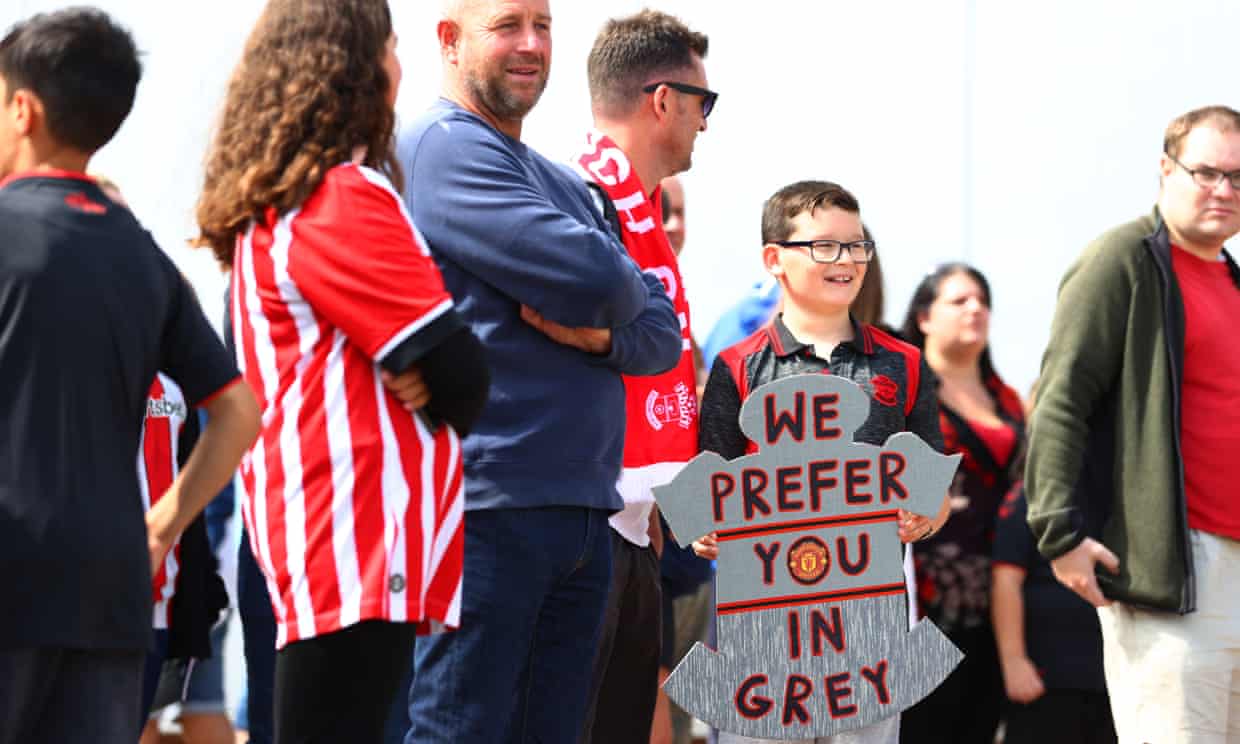 A Southampton fan arrives with a sign saying ‘we prefer you in grey’ sign, a nod to the Saints’ 6-3 win over Manchester United in 1996. 