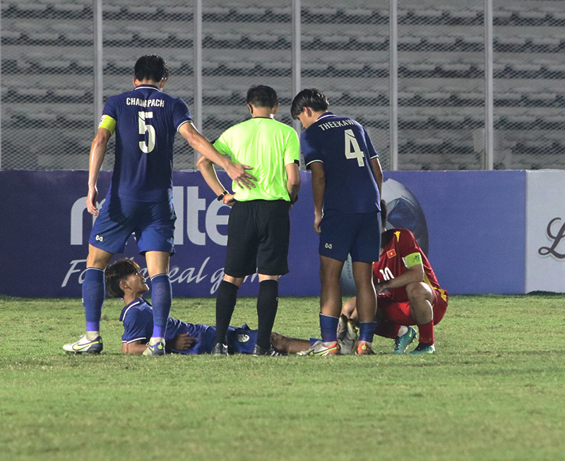 Khi trận đấu có tỹ số 1-1, cục diện trên sân đã nguội hẳn. Trong ảnh, Văn Khang đang chăm sóc cho cầu thủ U19 Thái Lan bị chuột rút