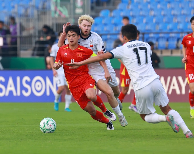 Văn Khang tranh bóng cùng cầu thủ U23 Kyrgyzstan - Ảnh: Ted Trần